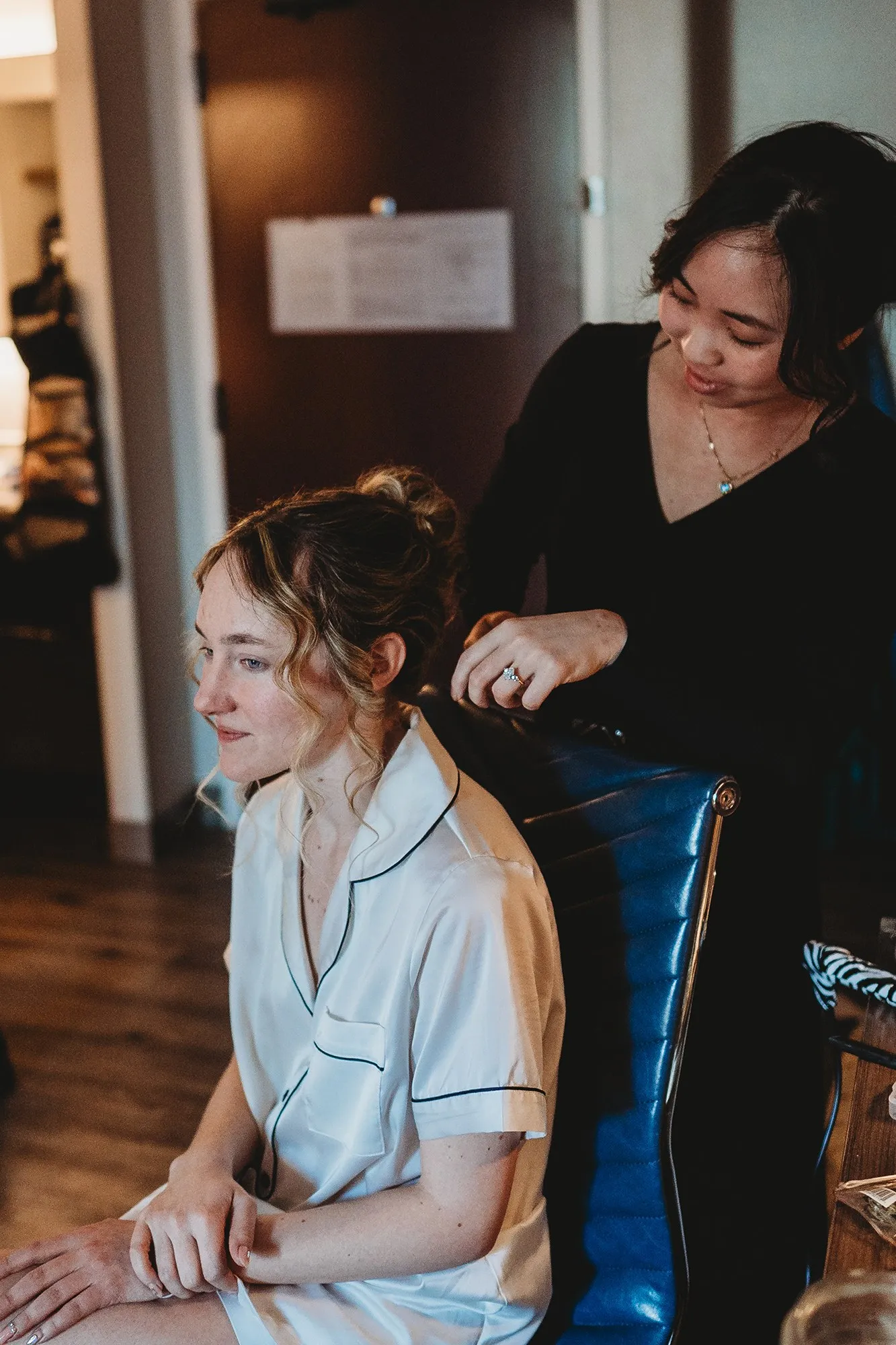 Elizabeth adjusting a bride's hair during getting-ready